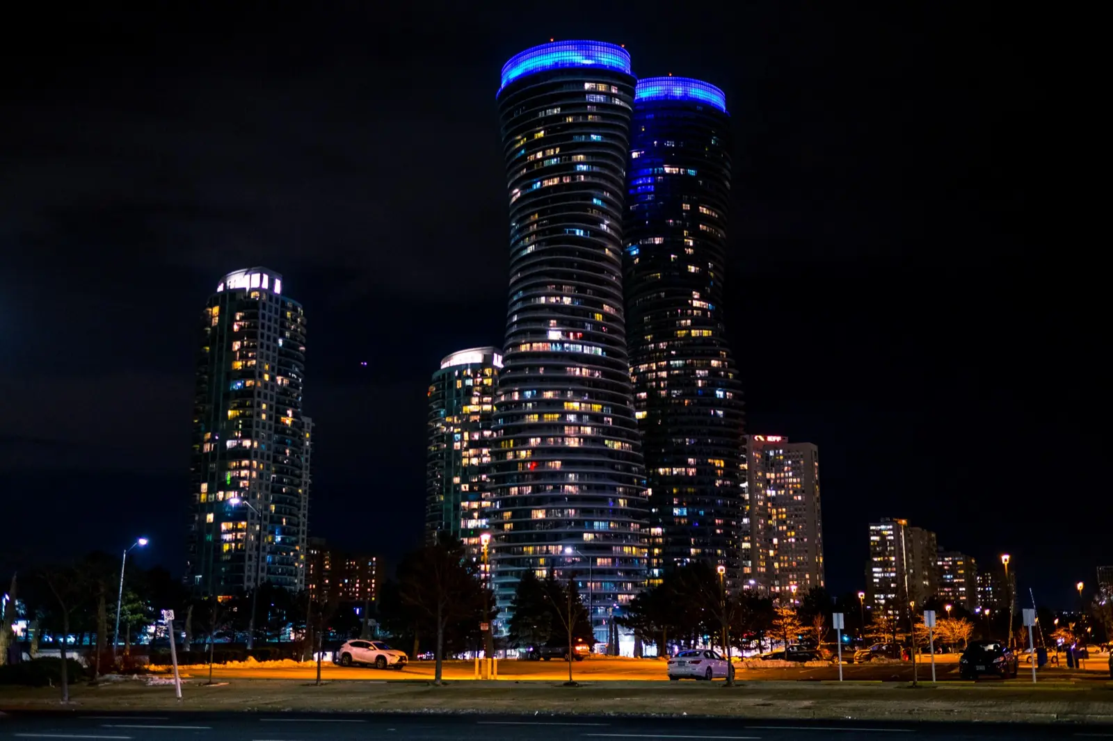 The Absolute World towers in Mississauga, lit up at night